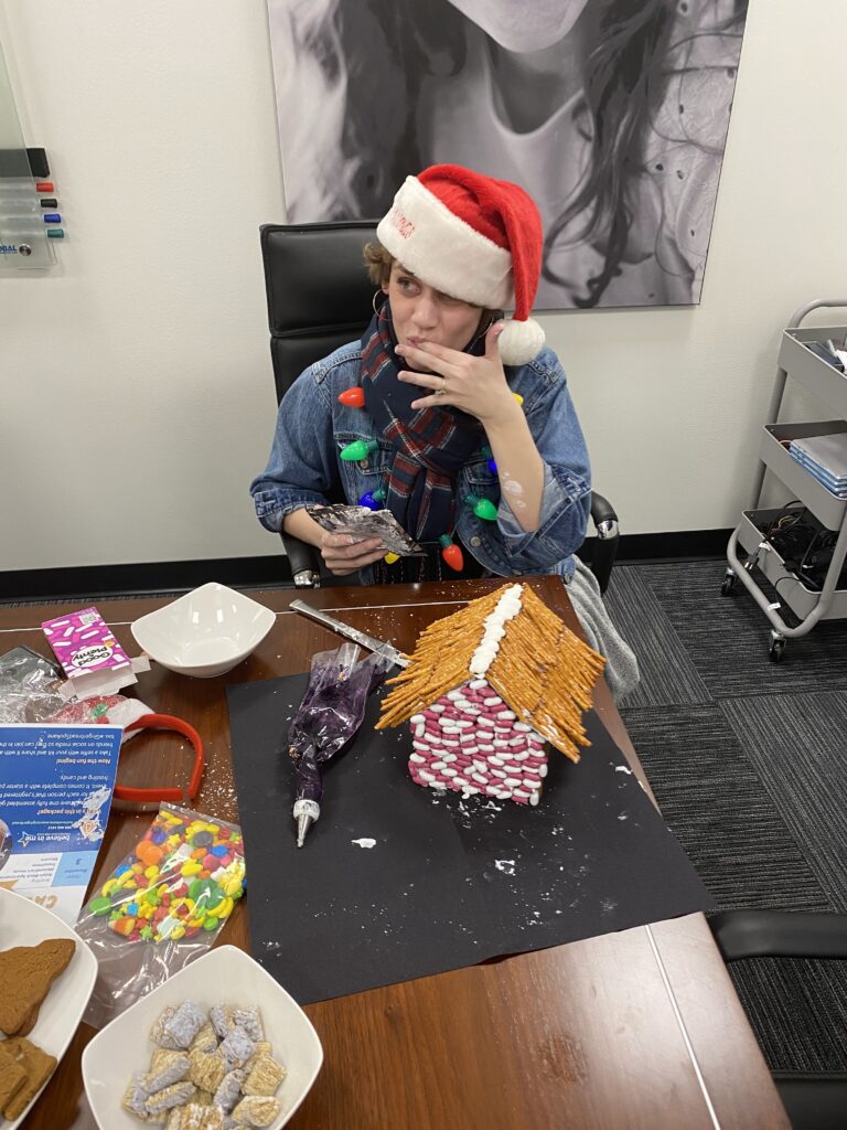 woman building a gingerbread house