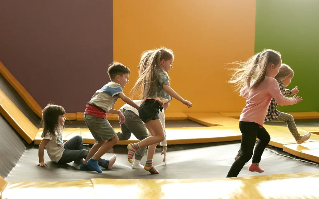 Kids running in a trampoline park.