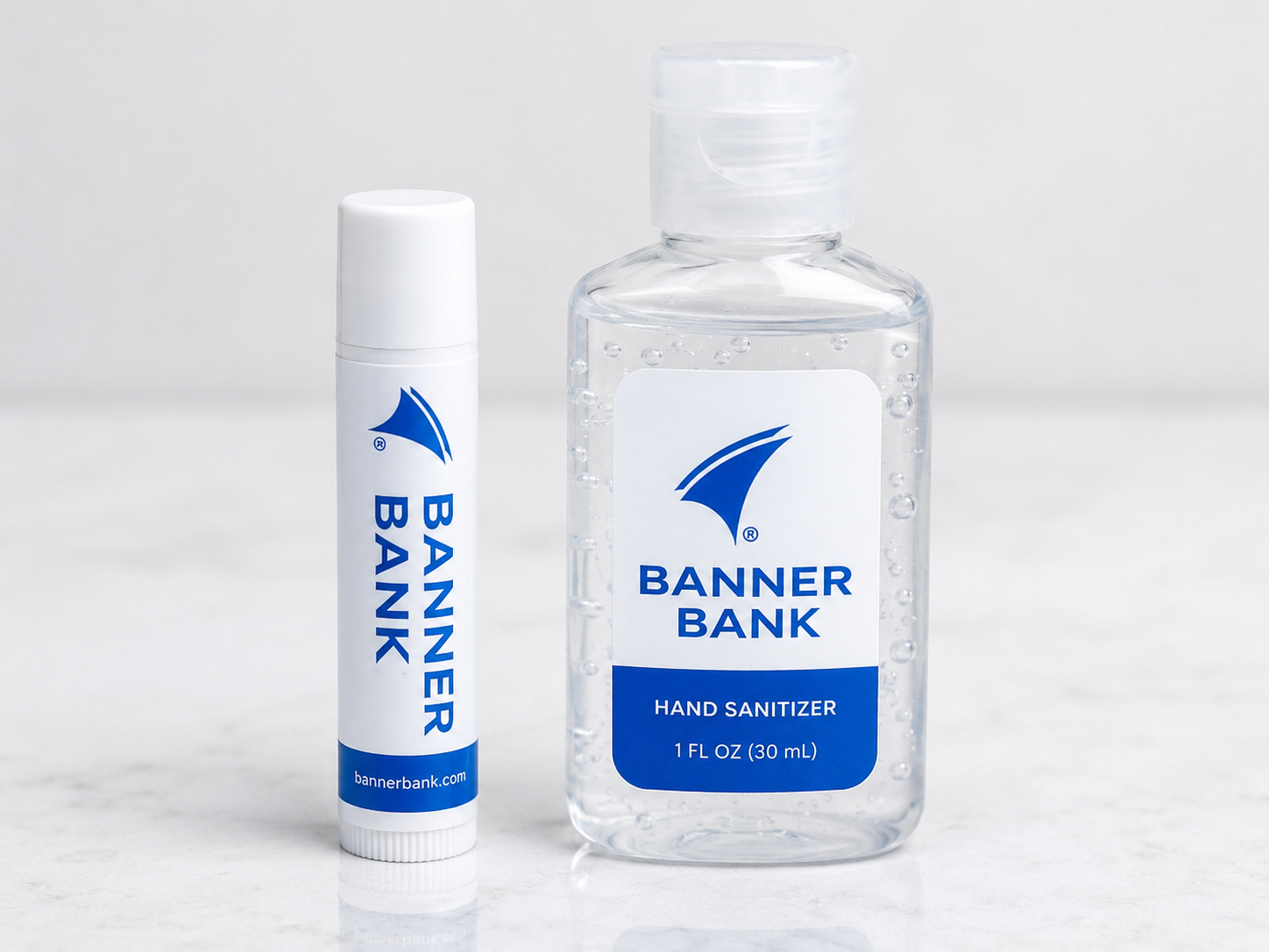 Hand sanitizer and lip balm representing practical goody bag essentials