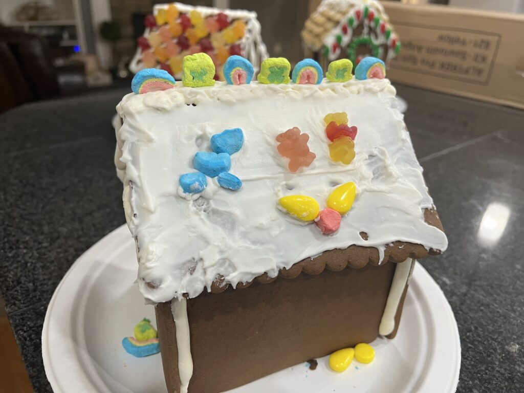 Decorated gingerbread house with icing and candy for the holiday season.