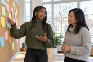 A teen shares her ideas with an adult facilitator, showing youth voice in community giving.
